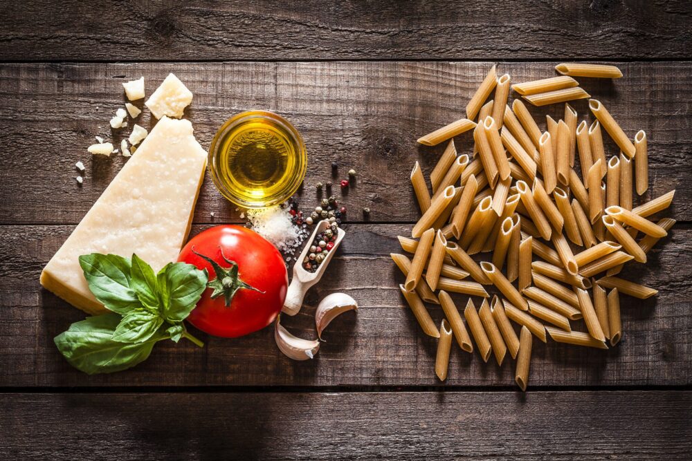 Wholegrain Penne Pasta With Ingredients On Rustic Wooden Table